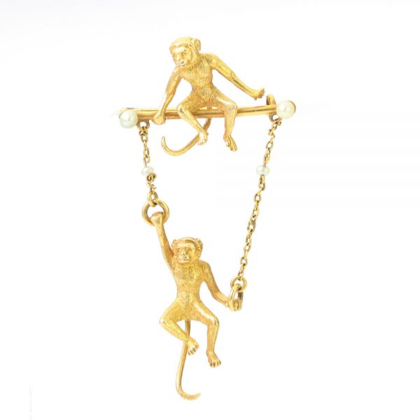 Art Deco 18ct Yellow Gold Monkey Brooch with Pearls; novelty "Monkey Around" brooch crafted from 18ct yellow gold with textured detailing and accented with two pearls. Made in France, Circa 1920