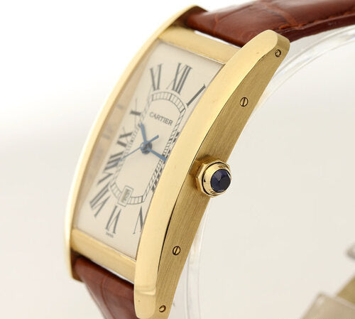 Cartier Tank Americaine Gents 18ct Yellow Gold Automatic, Ref 1740, white dial, Roman numerals, date indicator, blue steel hands, sapphire crown, sapphire crystal, on a Cartier brown leather strap with 18ct yellow gold pin buckle, with Cartier box and papers.