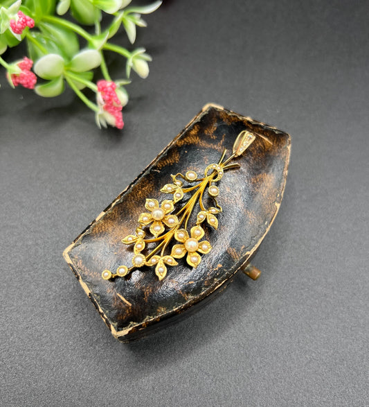 A yellow gold floral spray pendant with seed pearls