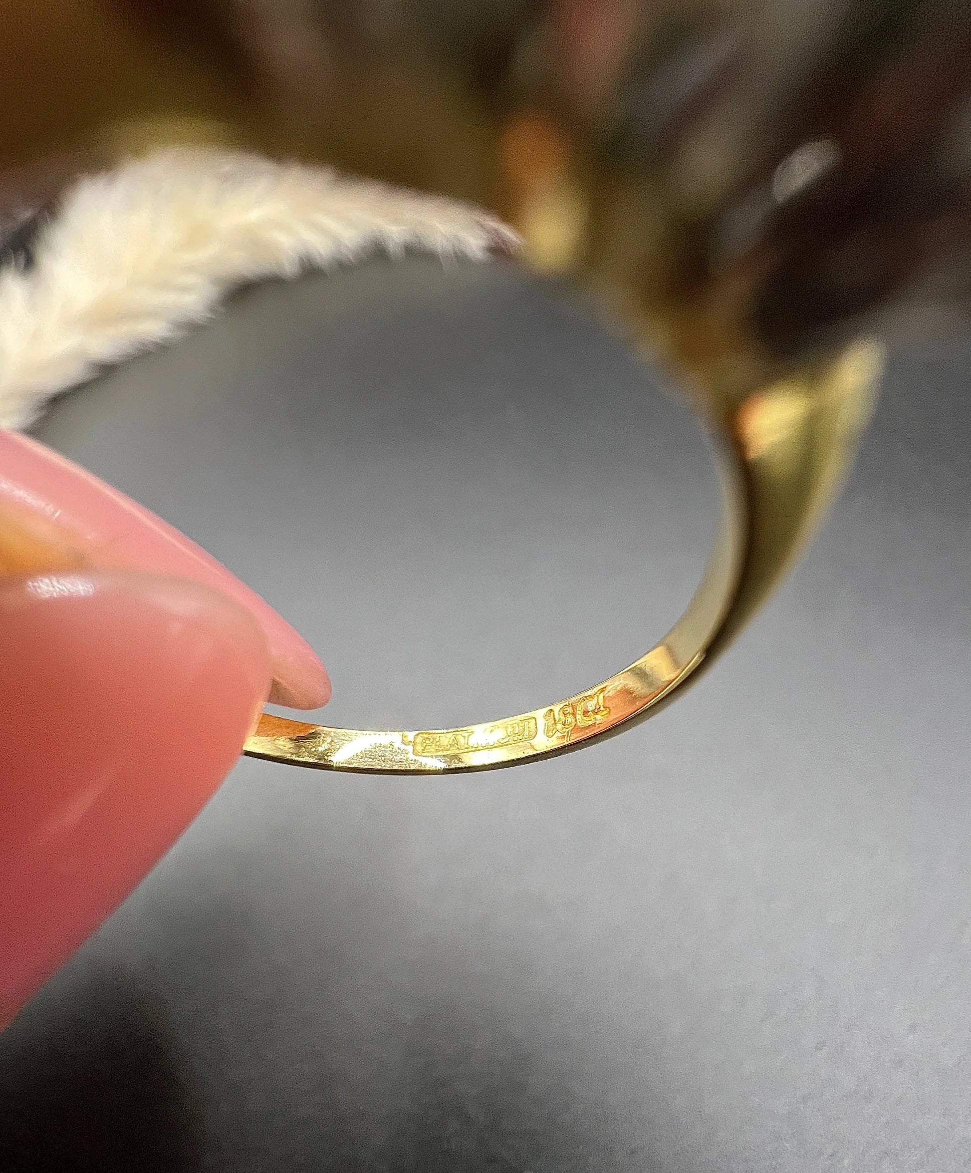 Stamps inside a yellow gold ring shank