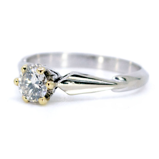 A single stone diamond ring in platinum with yellow gold claws