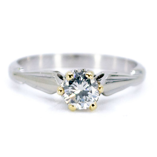 A single stone diamond ring in platinum with yellow gold claws