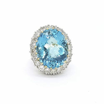 Aquamarine and Diamond Oval Cluster Cocktail Ring; 23.85ct oval aquamarine surrounded by 2.20cts brilliant-cut diamonds, in 18ct yellow gold.