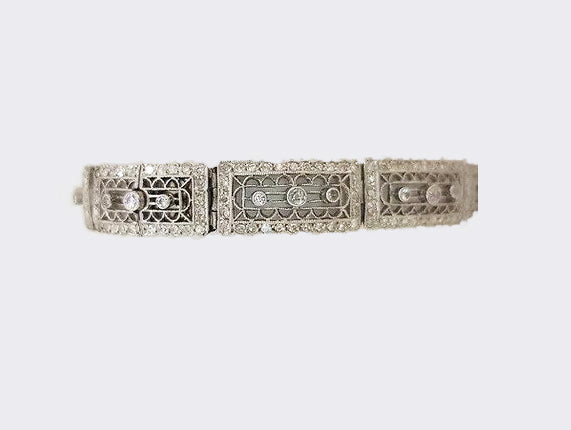 Art Deco Diamond and Platinum Filigree Panel Bracelet; Art Deco diamond filigree panel bracelet set with brilliant cut diamonds. Tests as platinum.