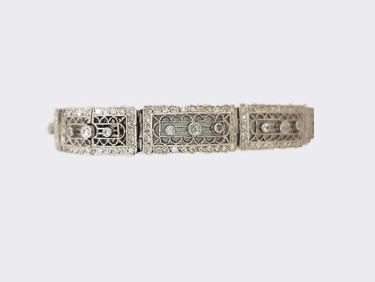 Art Deco Diamond and Platinum Filigree Panel Bracelet; Art Deco diamond filigree panel bracelet set with brilliant cut diamonds. Tests as platinum.
