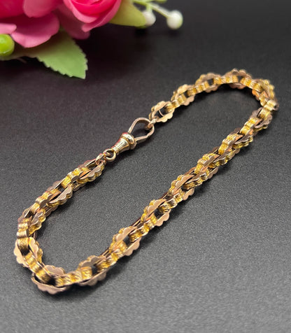 A fancy link yellow gold bracelet with a lobster claw clasp