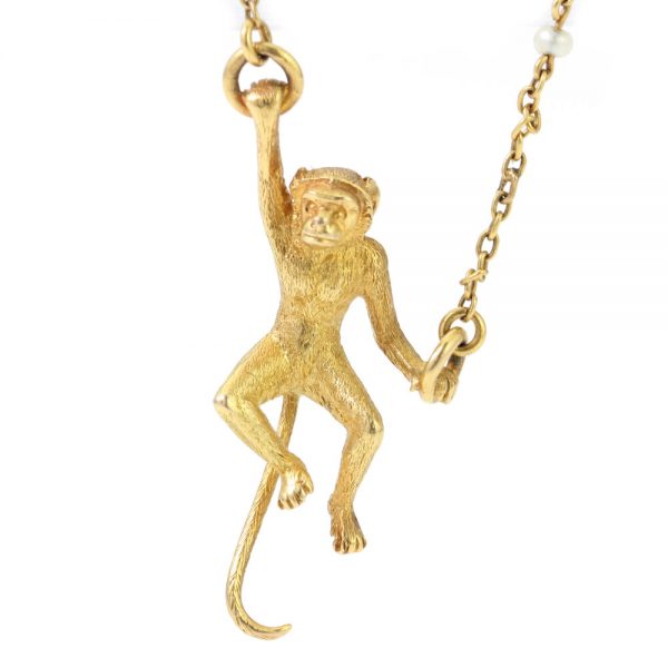 Art Deco 18ct Yellow Gold Monkey Brooch with Pearls; novelty "Monkey Around" brooch crafted from 18ct yellow gold with textured detailing and accented with two pearls. Made in France, Circa 1920