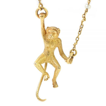 Art Deco 18ct Yellow Gold Monkey Brooch with Pearls; novelty "Monkey Around" brooch crafted from 18ct yellow gold with textured detailing and accented with two pearls. Made in France, Circa 1920