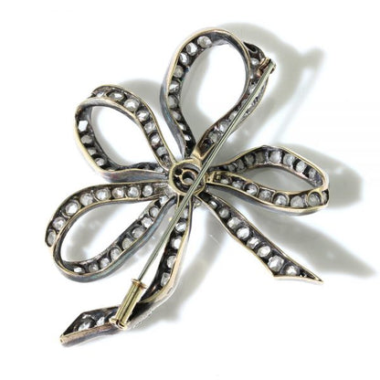 Antique Old Cut Diamond Bow Brooch; set with 6.55 carats of old-cut and rose-cut diamonds, in silver and 15ct gold, Circa 1830s