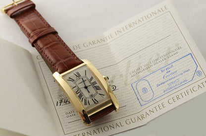 Cartier Tank Americaine Gents 18ct Yellow Gold Automatic, Ref 1740, white dial, Roman numerals, date indicator, blue steel hands, sapphire crown, sapphire crystal, on a Cartier brown leather strap with 18ct yellow gold pin buckle, with Cartier box and papers.