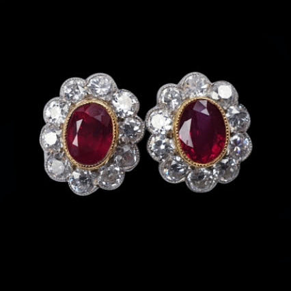 Ruby and Diamond Oval Cluster Stud Earrings; featuring 1.60 carats of bright crimson red oval faceted rubies surrounded by 2.00cts old cut diamonds, in 18ct gold