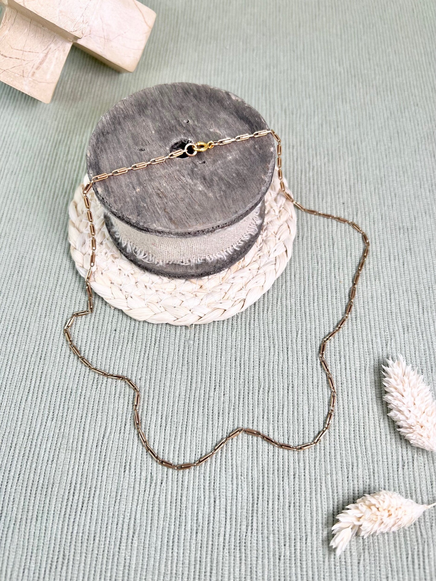 A gold paperclip link chain necklace