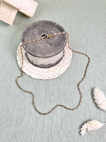 A gold paperclip link chain necklace