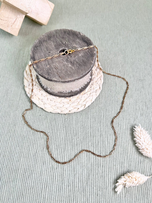 A gold paperclip link chain necklace