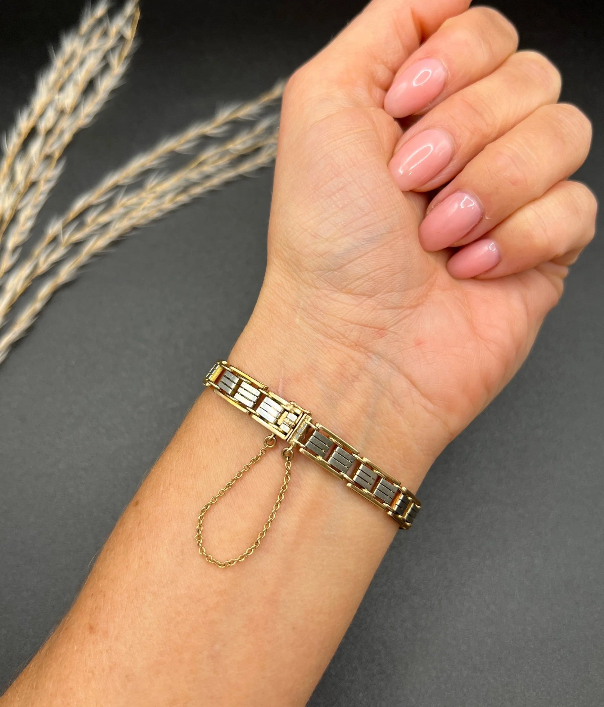 A gold and platinum gate bracelet, modelled on a wrist