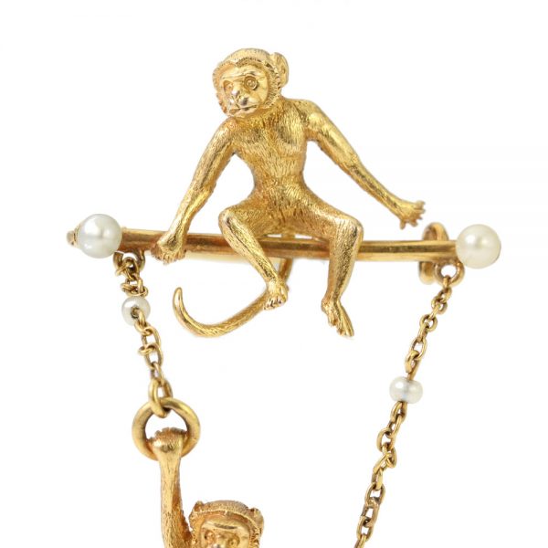 Art Deco 18ct Yellow Gold Monkey Brooch with Pearls; novelty "Monkey Around" brooch crafted from 18ct yellow gold with textured detailing and accented with two pearls. Made in France, Circa 1920