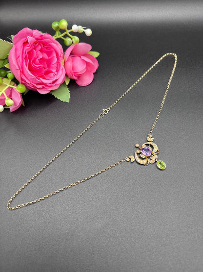 A yellow gold peridot, amethyst and seed pearl pendant necklace