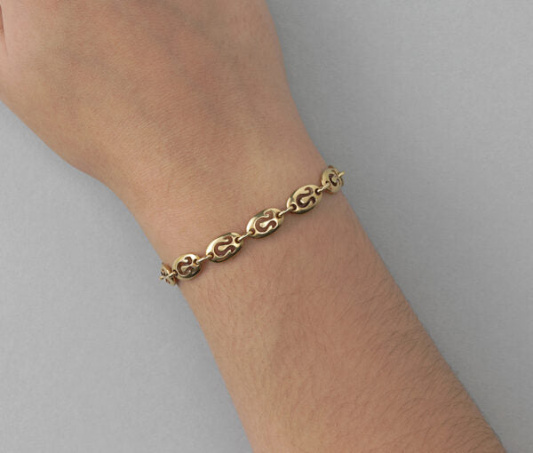 Van Cleef and Arpels Vintage 18ct Yellow Gold Leo Bracelet; chunky oval links with cut out Leo zodiac symbols. Circa 1970. Signed and numbered