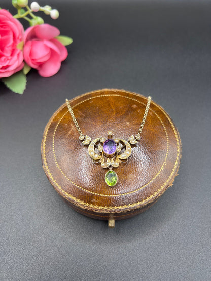 A yellow gold peridot, amethyst and seed pearl pendant necklace