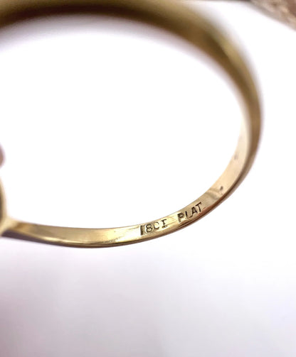 Close-up of 18CT PLAT stamps inside a yellow gold ring shank