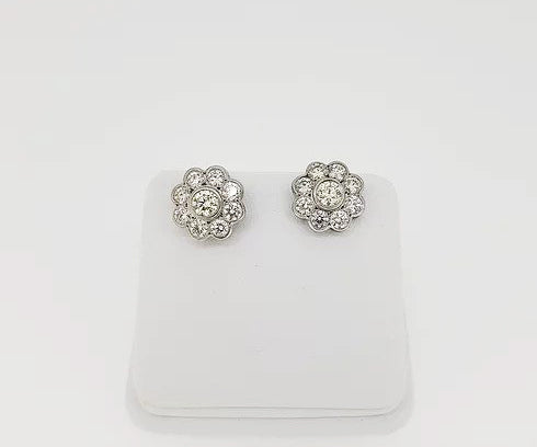 Diamond Daisy Flower Cluster Stud Earrings, mounted in 18ct white gold, in a rub-over setting with fine millegrain borders.