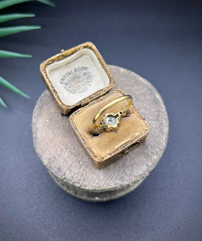 An emerald and diamond floral cluster ring in yellow gold and platinum