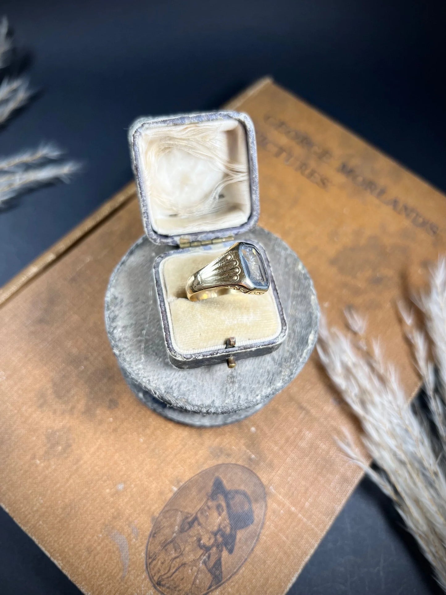 A yellow gold blue glass intaglio signet ring, in a ring box