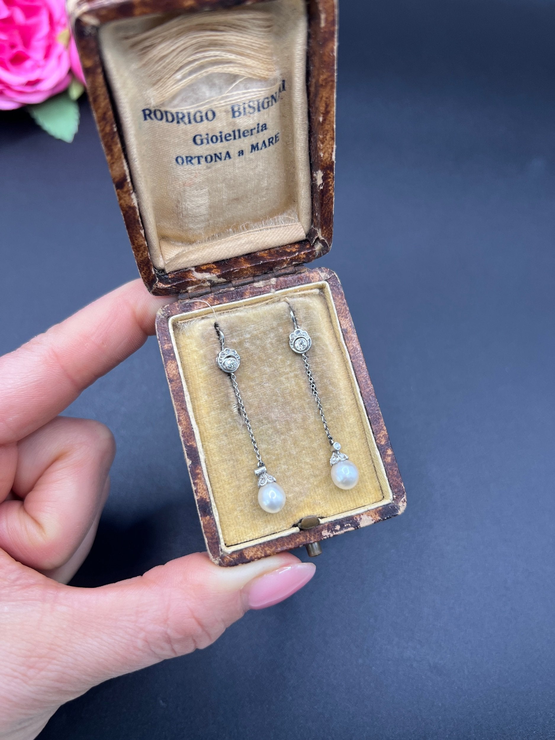 A pair of long drop platinum earrings with pearls and diamonds, in an antique box