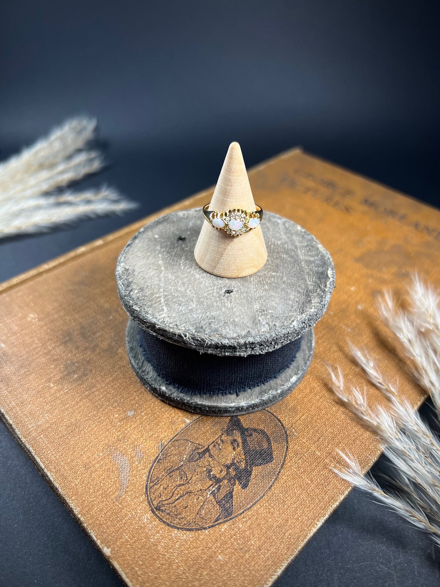 A yellow gold opal and diamond dress ring, on a ring cone
