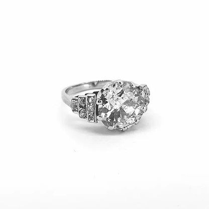 Vintage Old Cut Diamond Engagement Ring; central 4.10 carat old-cut diamond, ten-claw set, diamond set shoulders in a graduated geometric step design
