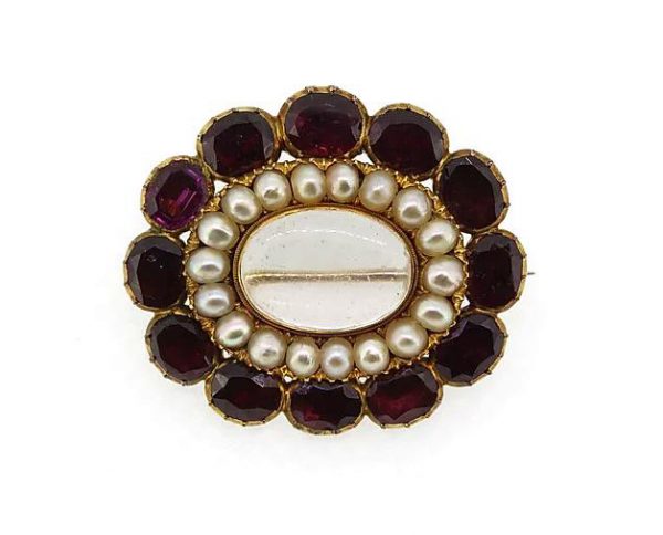 Antique Victorian Garnet and Pearl Memorial Locket Brooch; set with flat-cut oval faceted garnets and split pearls. Mounted in high carat gold. Circa 1860