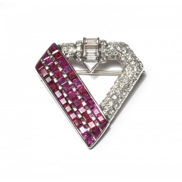Vintage 1940s Ruby Diamond and Platinum Brooch; one side comprised of three columns of 5.25cts calibre-cut rubies, with 3.50cts fancy-cut and brilliant-cut diamonds set on the rest of the brooch