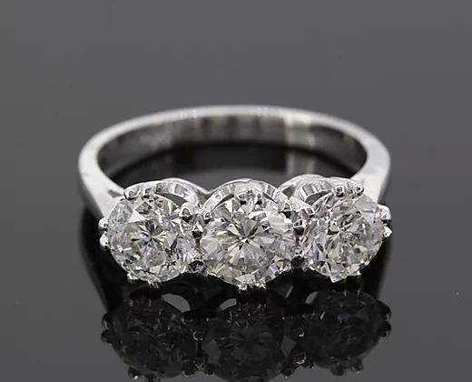 Classic Three Stone Diamond Ring, featuring three round brilliant-cut diamonds totaling 2.34 carats. Mounted in platinum. Diamond colour: G