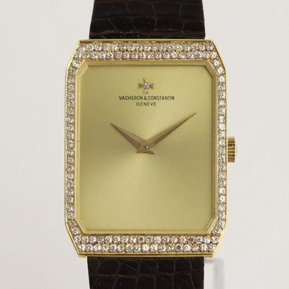Vacheron Constantin 18ct Yellow Gold Manual Watch with Diamond Bezel; gold colour dial, original diamond bezel and diamond on dial at the centre of the Vacheron Constantin logo, on a Vacheron Constantin dark brown leather strap