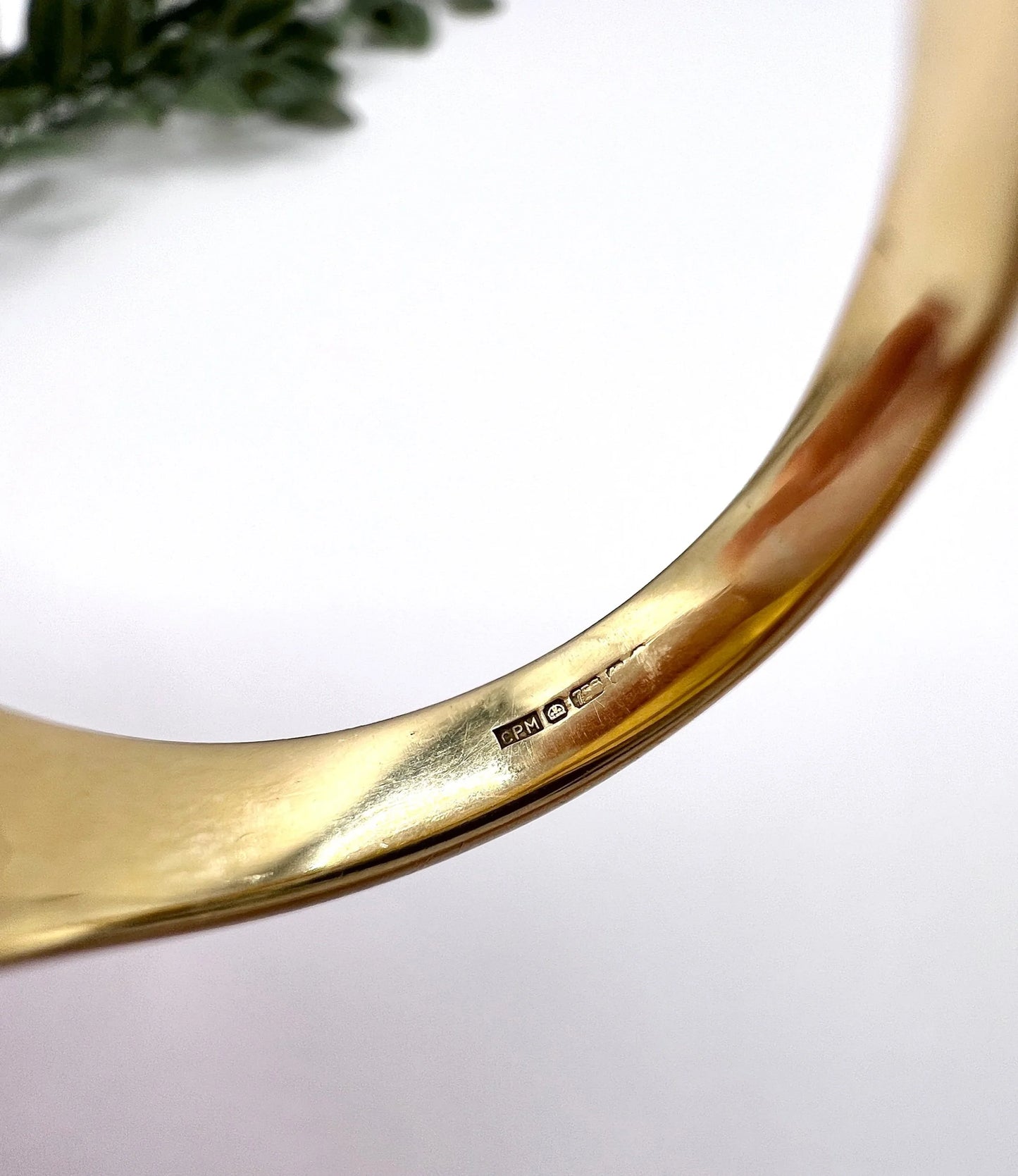 A faded 18 carat gold hallmark inside a yellow gold ring shank