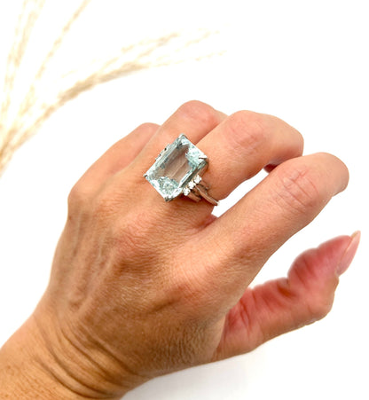 An aquamarine and diamond cocktail ring in white gold, modelled on a hand