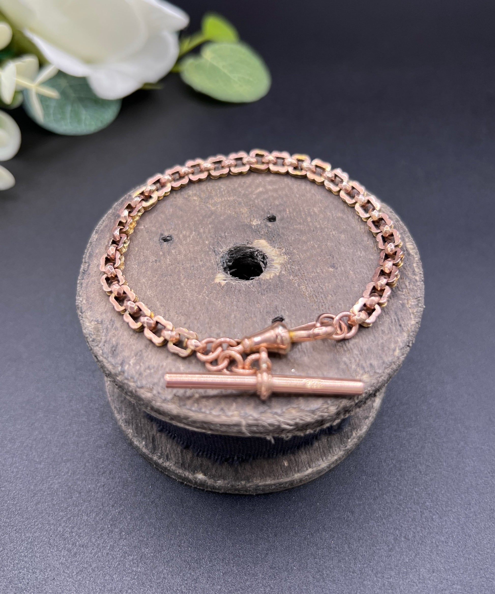 A fancy link rose gold bracelet with a T-bar and dog clip clasp