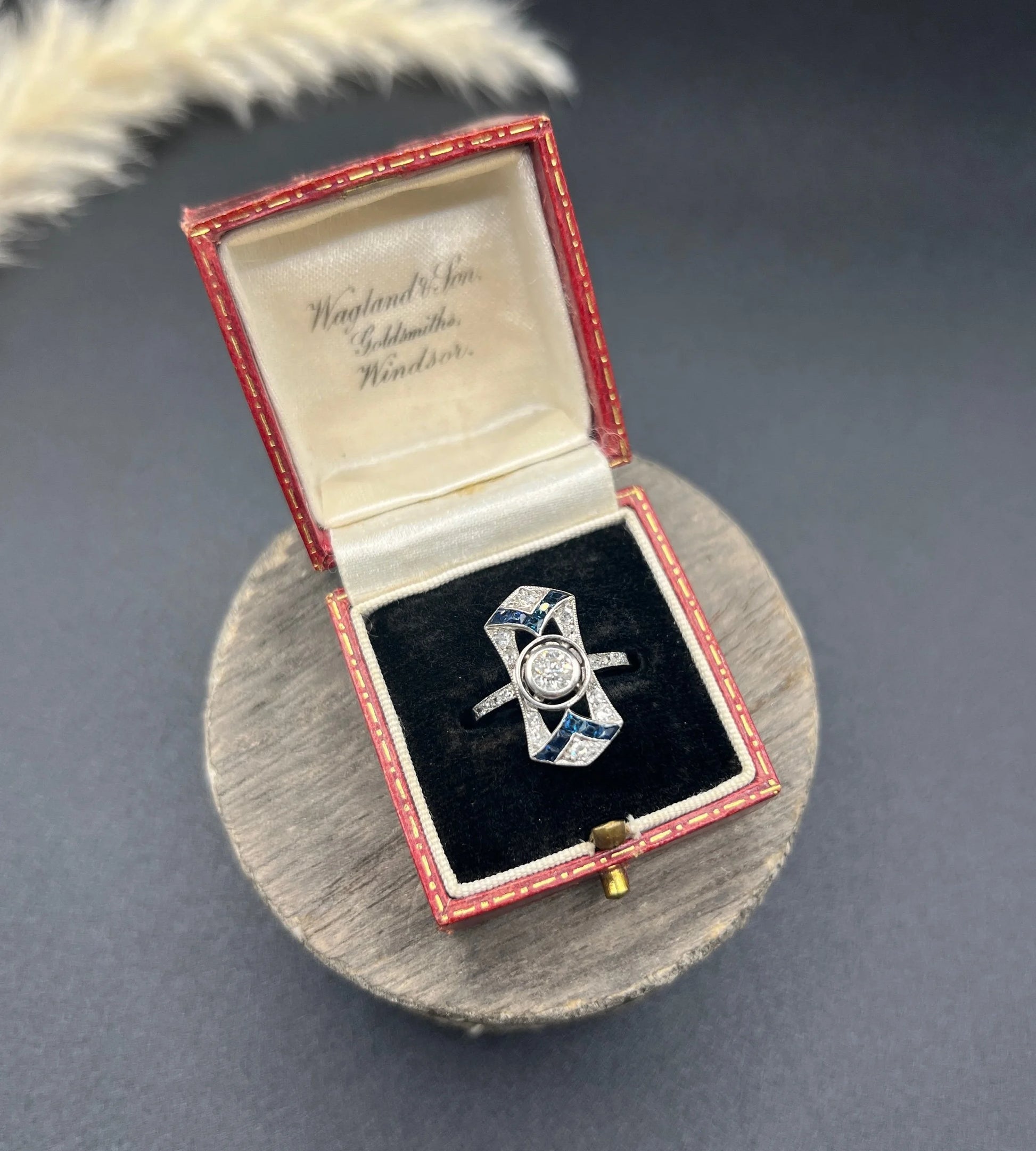 An Art Deco design sapphire and diamond ring in white gold, in a red antique ring box