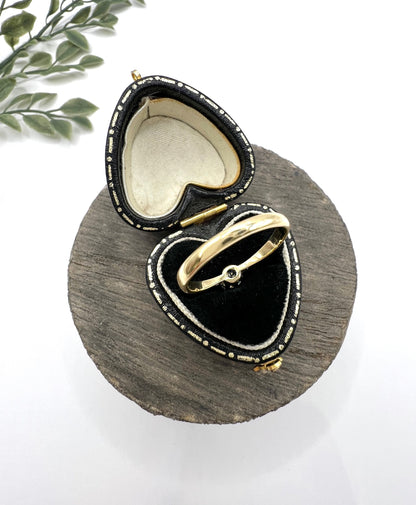 A single stone brilliant cut diamond ring claw set in platinum and yellow gold, in a heart-shaped ring box