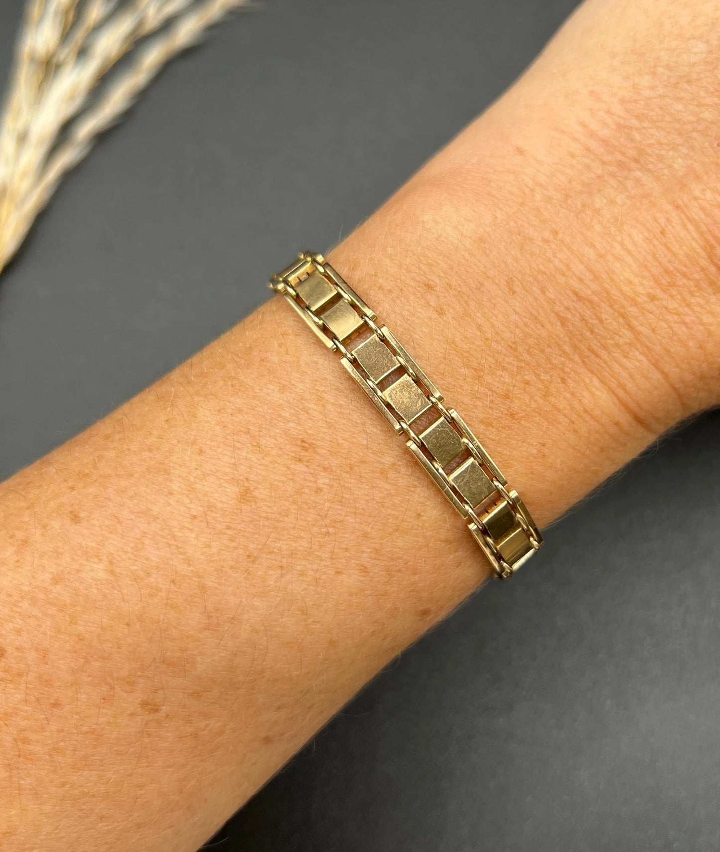 A gold and platinum gate bracelet, modelled on a wrist