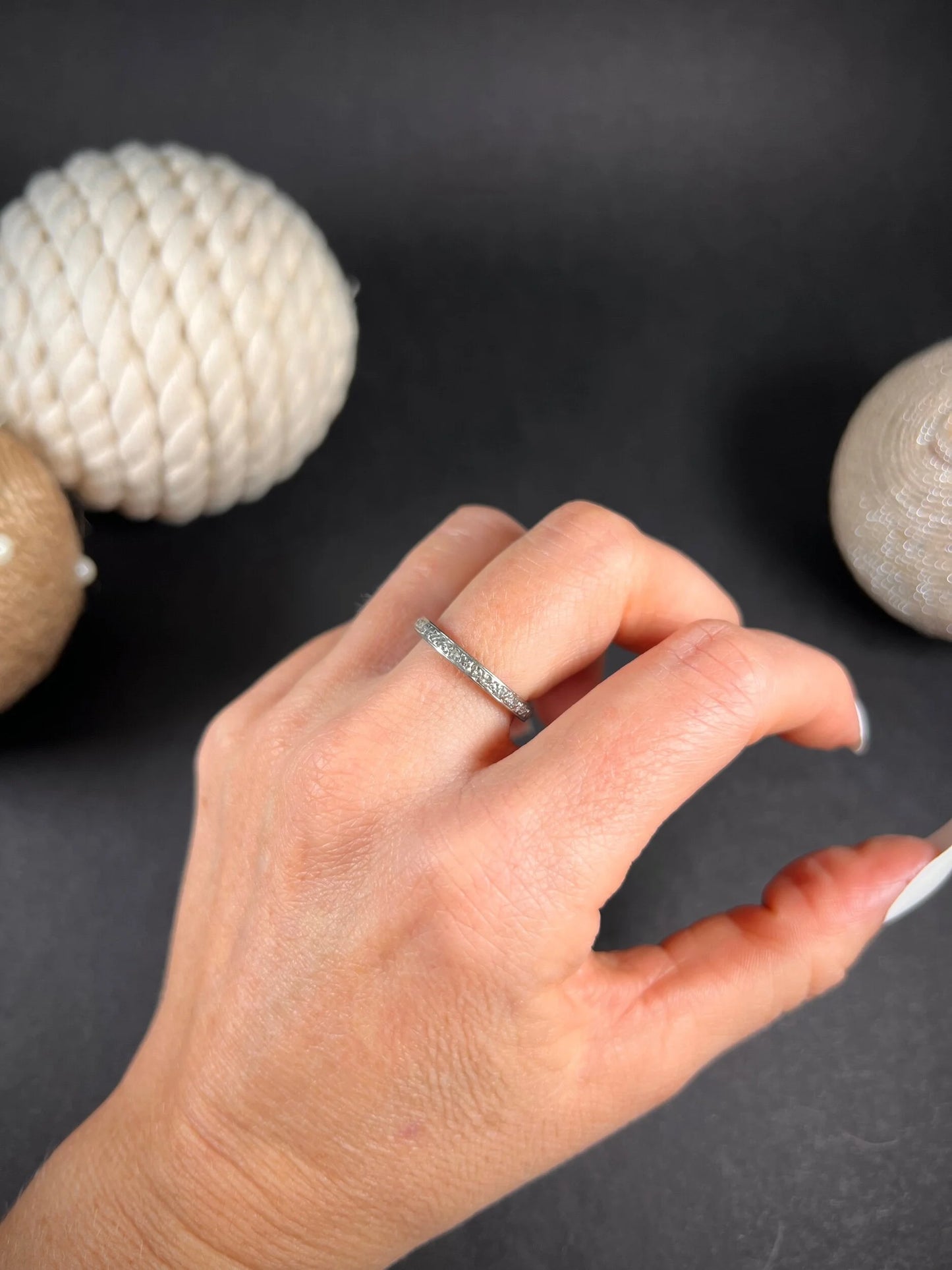 A full eternity ring in white gold, set with diamonds, modelled on a hand