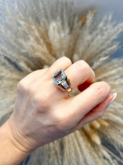An aquamarine and diamond cocktail ring in gold, modelled on a hand