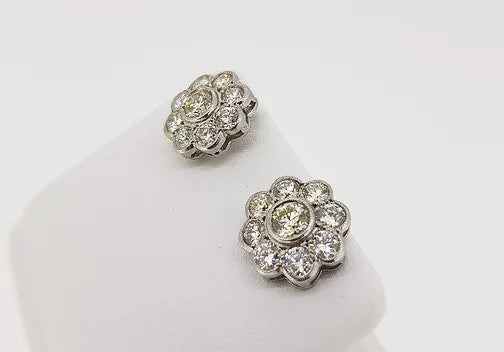Diamond Daisy Flower Cluster Stud Earrings, mounted in 18ct white gold, in a rub-over setting with fine millegrain borders.