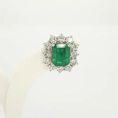 Emerald Cut Emerald and Diamond Cluster Stud Earrings; 4.25cts emerald-cut emeralds surrounded by 2.30cts round brilliant-cut diamonds, in 18ct white gold