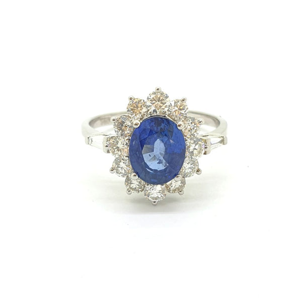 2.10ct Oval Sapphire and Diamond Cluster Engagement Ring with tapered baguette diamond shoulders