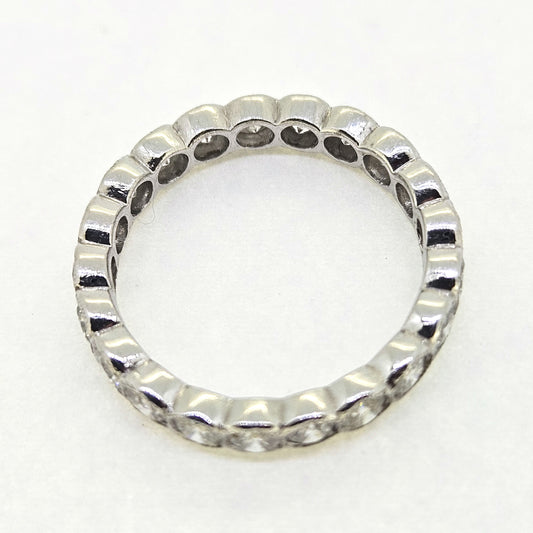 A diamond full eternity ring in 18ct white gold, on a white background