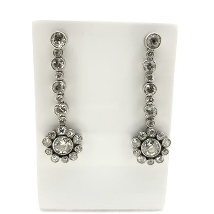 Diamond Flower Cluster Drop Earrings; 6.00 carat diamond drop earrings, diamond floral clusters suspended from diamond set drops comprised of alternating sized diamonds, in 18ct white gold