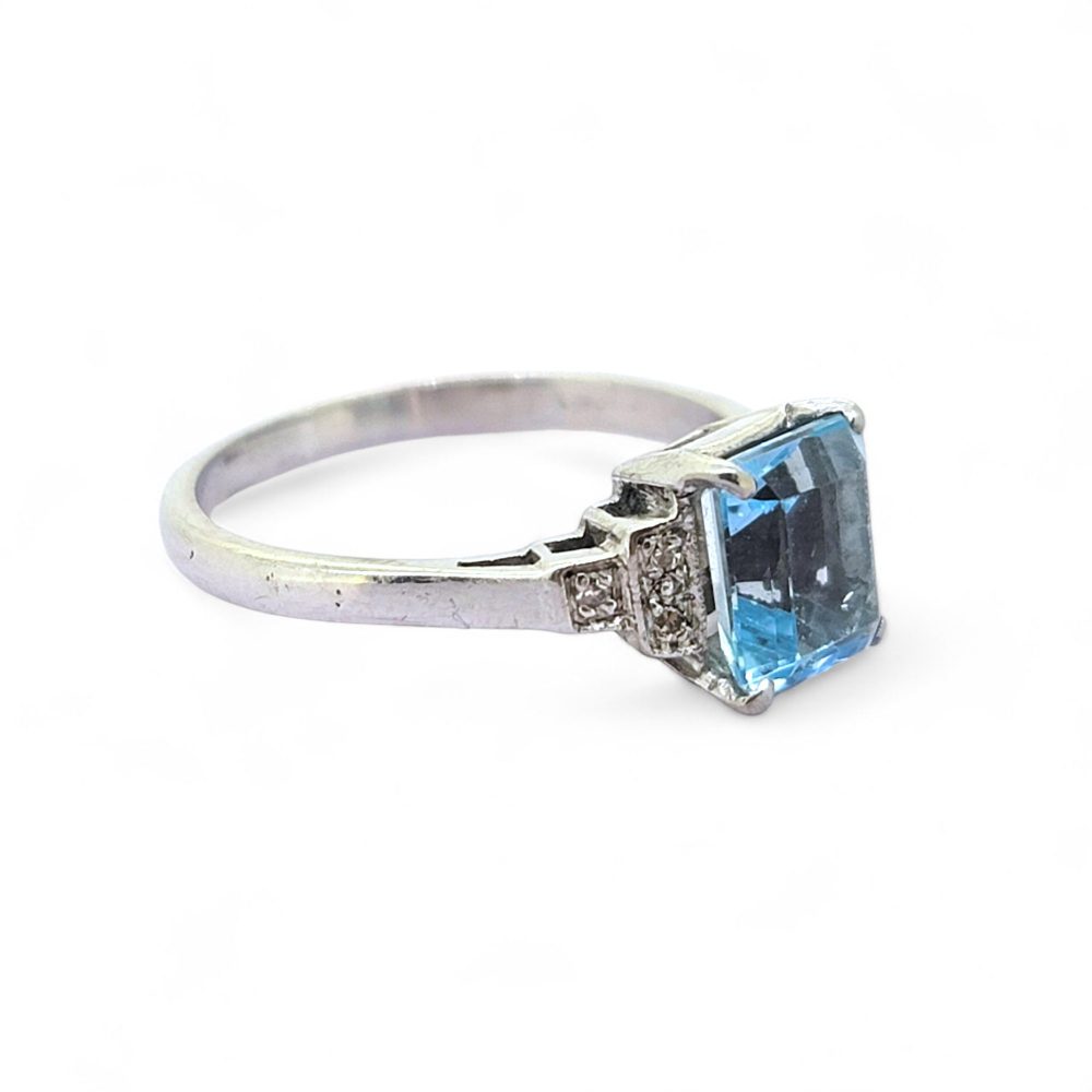 Aquamarine and Diamond Engagement Ring, rectangular step-cut aquamarine flanked by stepped brilliant-cut diamond-set shoulders in 18ct white gold