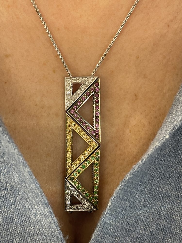 Contemporary Abstract Precious Gemstone Pendant, unusual multi-gemstone pendant comprising five triangular sections individually threaded onto the chain, set with diamonds, pink and yellow sapphires, and tsavorite garnets in 18ct white gold