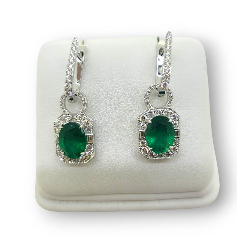 Contemporary 3.16ct Oval Emerald and Diamond Cluster Drop Earrings in 18ct White Gold, oval and diamond clusters suspended from horseshoe shaped diamond tops that can be worn with or without the drop